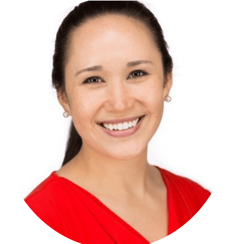 Professional headshot of smiling woman in red top with white background